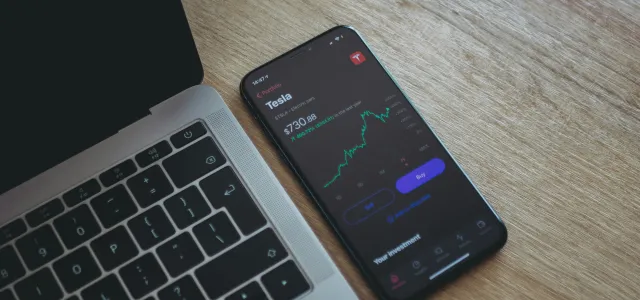 black android smartphone on macbook pro by Aidan Hancock courtesy of Unsplash.