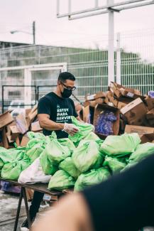 a man in a black shirt and some bags by Claudia Raya courtesy of Unsplash.