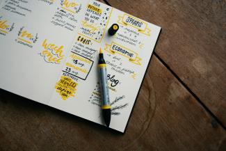 black and gray pen on table by Estée Janssens courtesy of Unsplash.