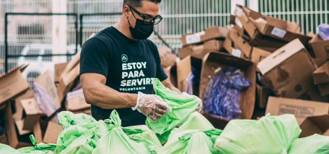 a man in a black shirt and some bags by Claudia Raya courtesy of Unsplash.