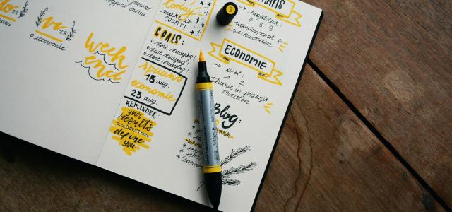 black and gray pen on table by Estée Janssens courtesy of Unsplash.