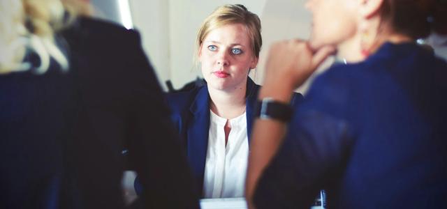 three women sitting beside table by Tim Gouw courtesy of Unsplash.